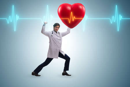 Doctor cardiologist supporting cardiogram heart lineの写真素材