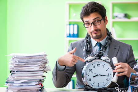 Employee chained to his desk due to workloadの写真素材