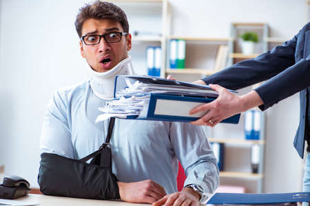 Injured man getting more work from his bossの写真素材