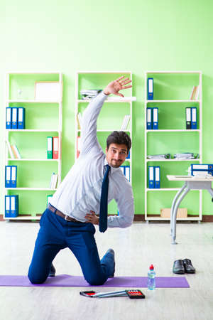 Employee doing exercises during break at workの写真素材
