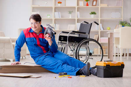 Disabled man laying floor laminate in officeの写真素材
