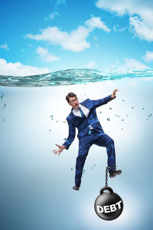 Businessman drowning in concept of high debtの写真素材