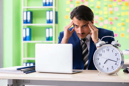 Businessman with many conflicting priorities in time managementの写真素材