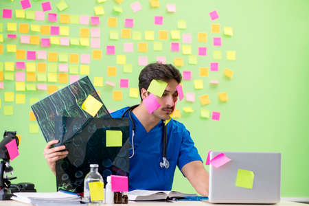 Young doctor with many reminders and urgent work