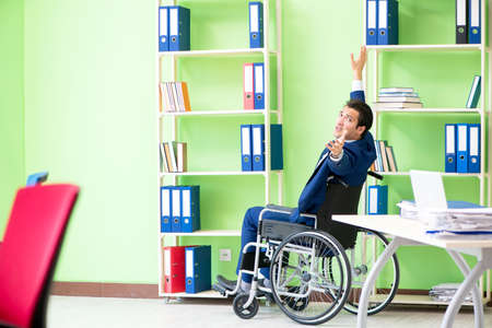 Disabled businessman working in the officeの写真素材