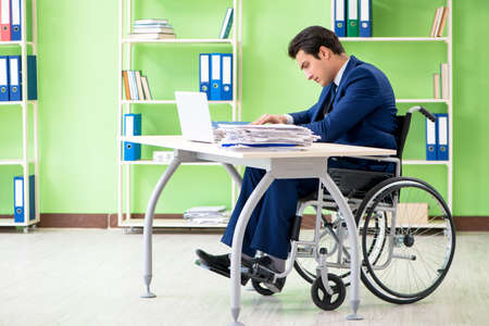 Disabled businessman working in the officeの写真素材