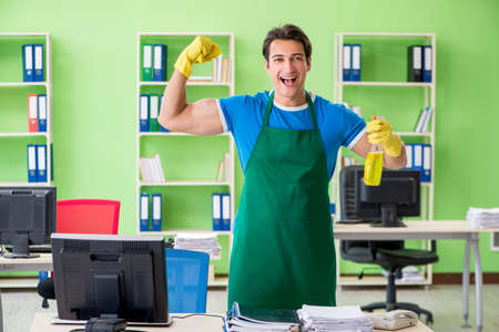 Male handsome professional cleaner working in the officeの写真素材