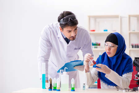 Two chemists working in the lab
