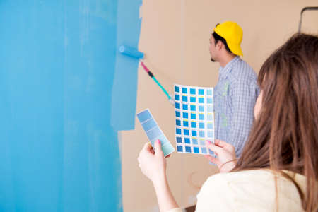 Husband and wife doing renovation at homeの写真素材