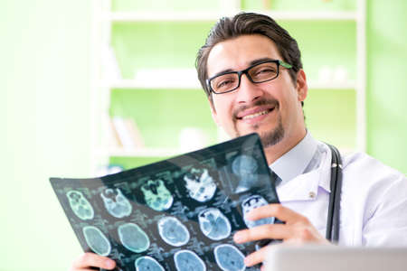 Doctor radiologist looking at x-ray scan in hospital