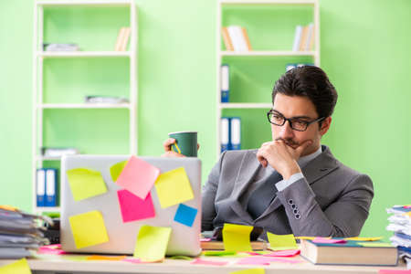 Businessman unhappy with many conflicting priorities sitting inの写真素材