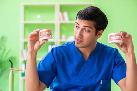 Man dentist working on new teeth implant