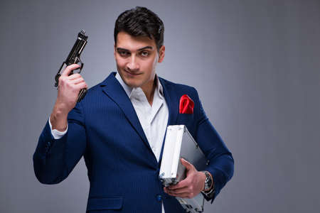 Handsome man against gray backgroundの写真素材