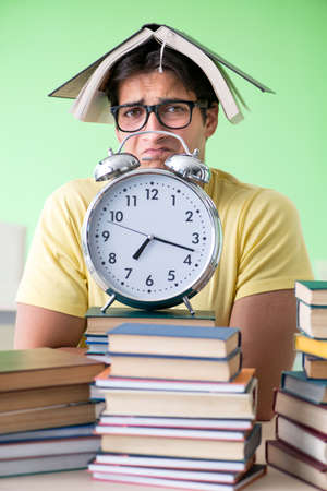 Student with too many books to read before examの写真素材