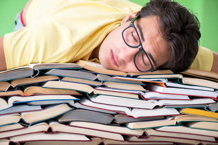 Student with too many books to read before examの写真素材