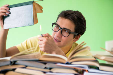 Student with too many books to read before examの写真素材