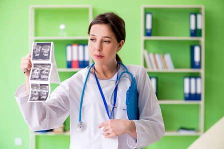 Female doctor gynecologyst writing medical record in the clinic