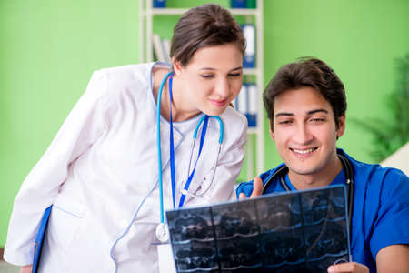 Woman and man gynecologists discussing medical case at the clini