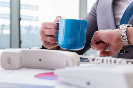Businessman drinking coffee in the office