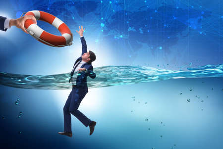 Businessman being saved from drowning