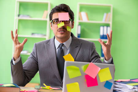 Businessman unhappy with many conflicting priorities sitting in
