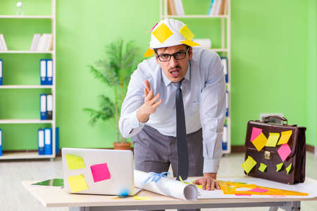 Male engineer working on new project with many conflicting priorの写真素材