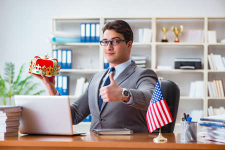 Businessman with American flag in officeの写真素材
