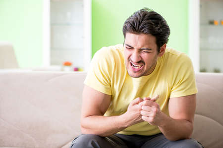 Young man at home after injuryの写真素材