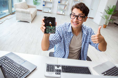 Technician with broken hard drive