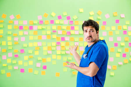 Young doctor with many reminders and urgent work