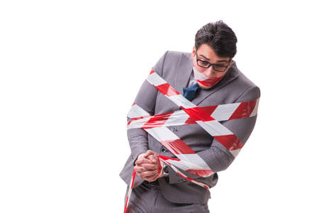 Businessman tied by tape isolated on whiteの写真素材