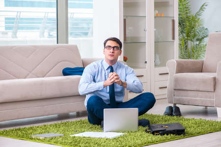 Businessman taking work home and working overtimeの写真素材