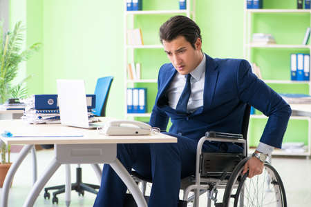 Disabled businessman working in the officeの写真素材