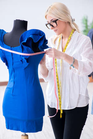 Woman tailor working on new dress designsの写真素材