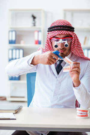 Arab dentist working on new teeth implantの写真素材