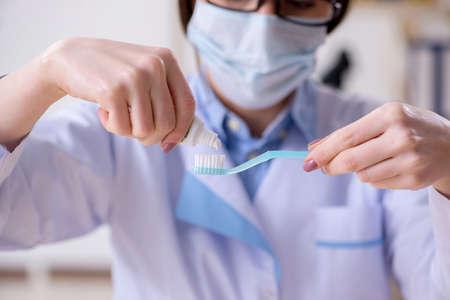 Woman dentist practicing work on tooth modelの写真素材