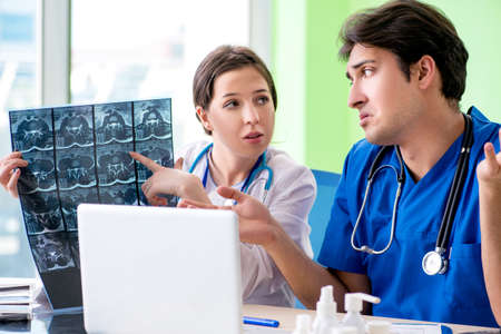 Woman and man gynecologists discussing medical case at the clinic