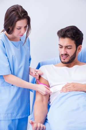 Woman doctor examining male patient in hospital