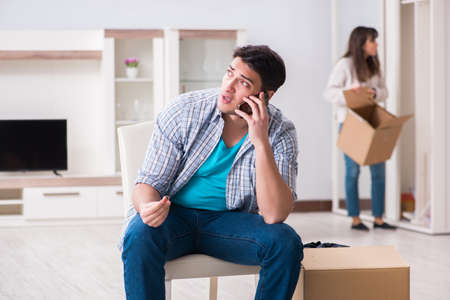 Woman evicting man from house during family conflictの写真素材