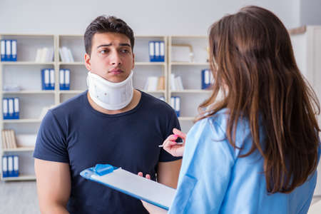Man with neck injury visiting doctor for check-upの写真素材