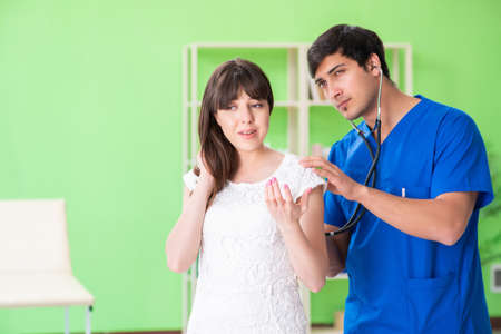 Female patient visiting male doctor in medical concept