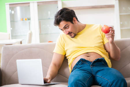 Man suffering from extra kilos in dieting conceptの写真素材