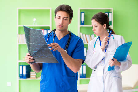 Woman and man gynecologists discussing medical case at the clini