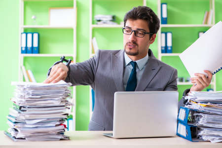 Employee chained to his desk due to workloadの写真素材