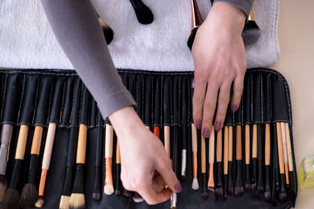 Make-up artist preparing brushes for workの写真素材