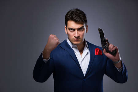 Handsome man against gray backgroundの写真素材