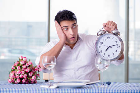 Handsome man alone in restaraunt on dateの写真素材