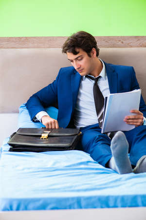 Businessman working in the hotel roomの写真素材