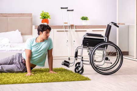 Young handsome disabled man recovering at homeの写真素材