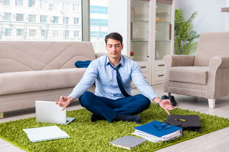 Businessman taking work home and working overtimeの写真素材